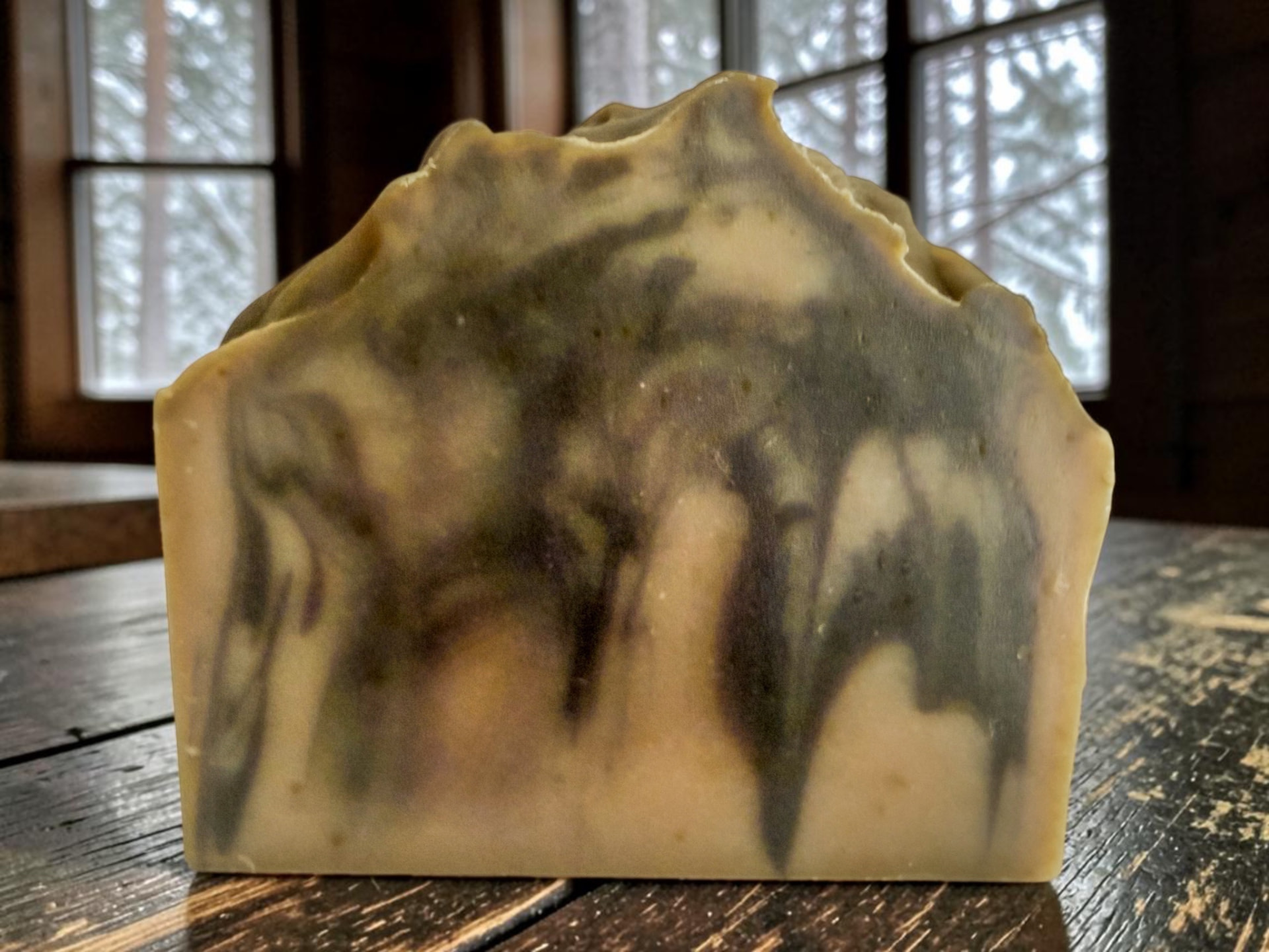 Winter In Soap, a cozy handmade bar with frosted pine and warm vanilla tones